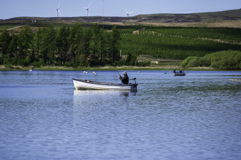 An angler with a fish on the line